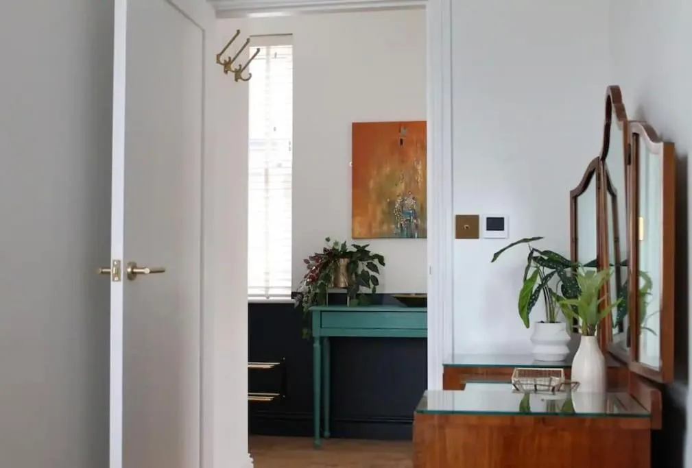 a hallway with a desk and a table with plants at Clement House, York, Free EV and parking in York