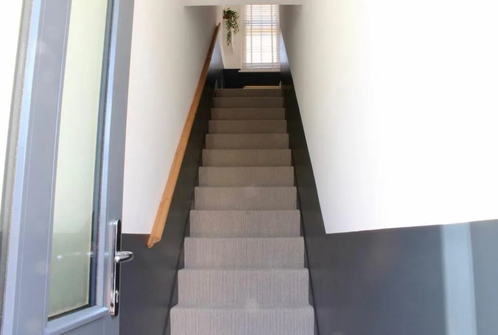 a staircase in a building with a stair case at Clement House, York, Free EV and parking in York